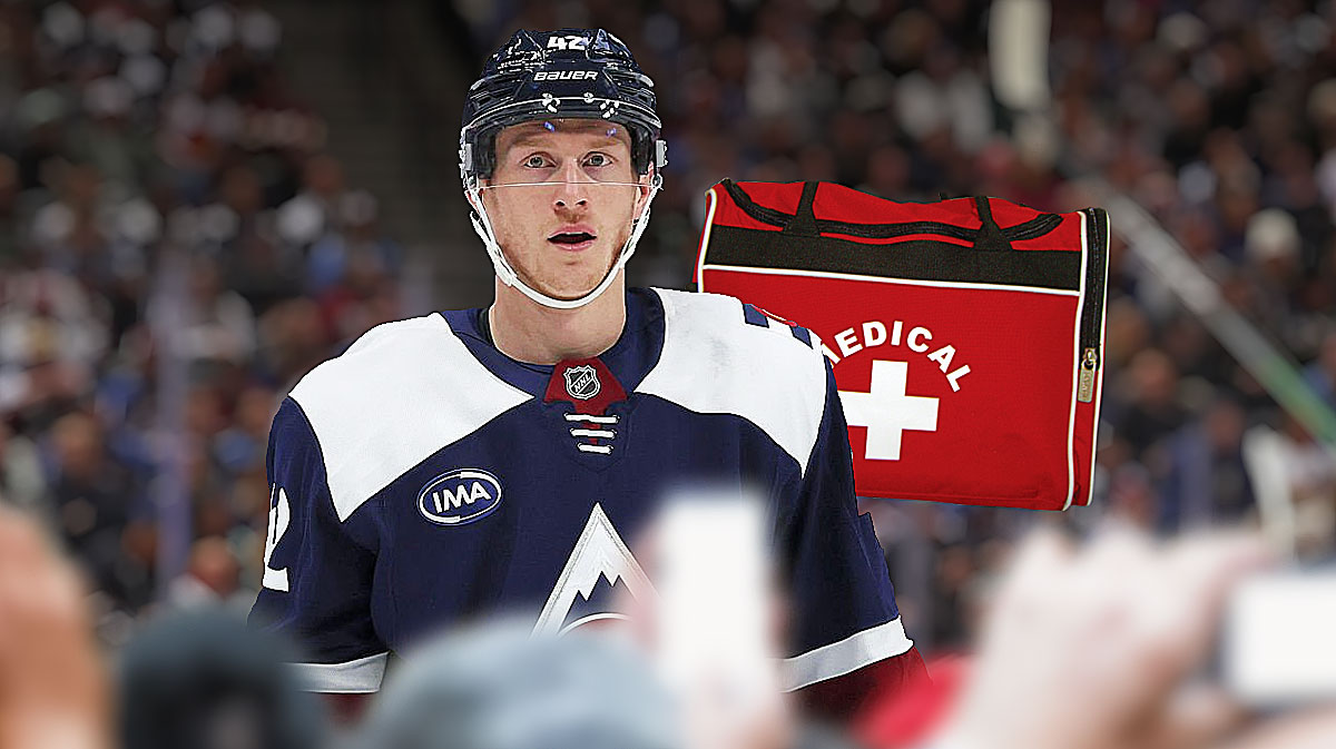 Josh Manson looking stern, first aid kit, hockey rink in background Colorado Avalanche