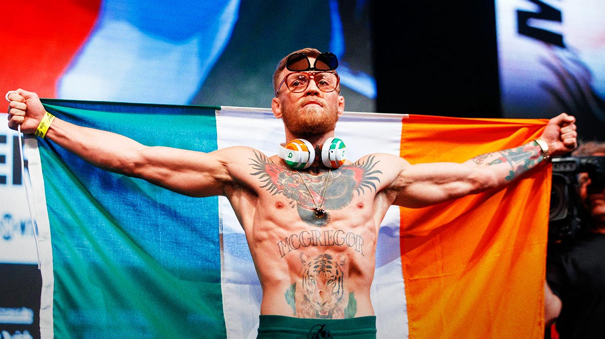 Conor McGregor holds the Irish flag of Ireland during weigh ins for the upcoming boxing match at T-Mobile Arena.