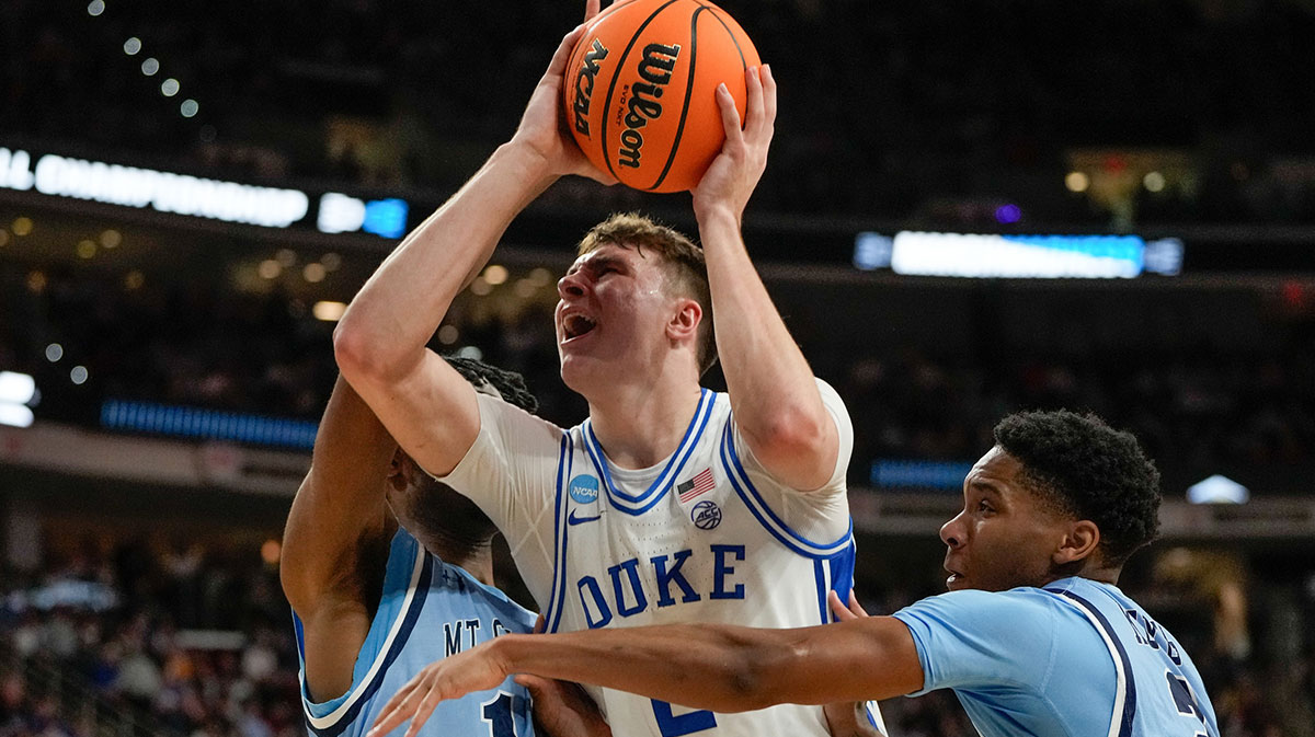 Mount St. Mary's Mountaineers forward Jedy Cordilia (14) and guard Arlandus Keyes (2) defend against Duke Blue Devils forward Cooper Flagg (2) during the first half in the first round of the NCAA Tournament at Lenovo Center. 