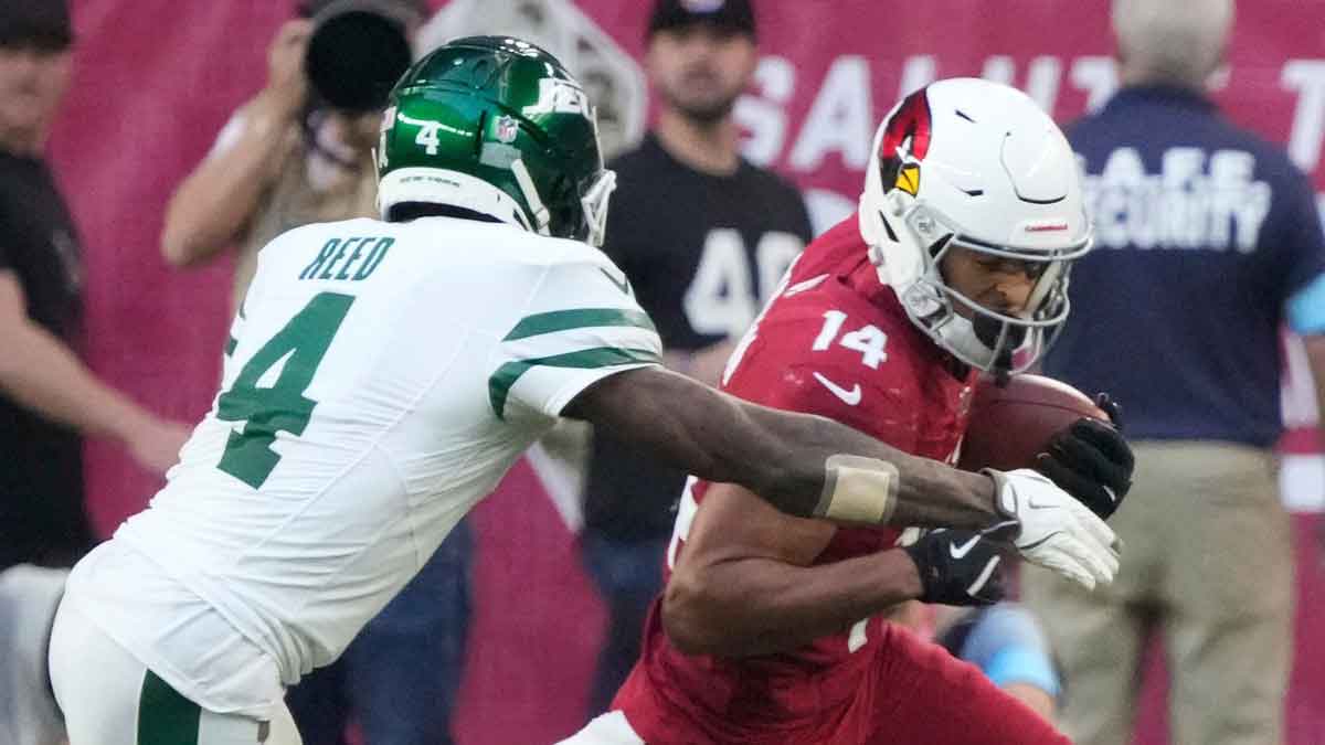 Arizona Cardinals wide receiver Michael Wilson (14) is tackled by New York Jets cornerback D.J. Reed (4) after a catch during the third quarter.