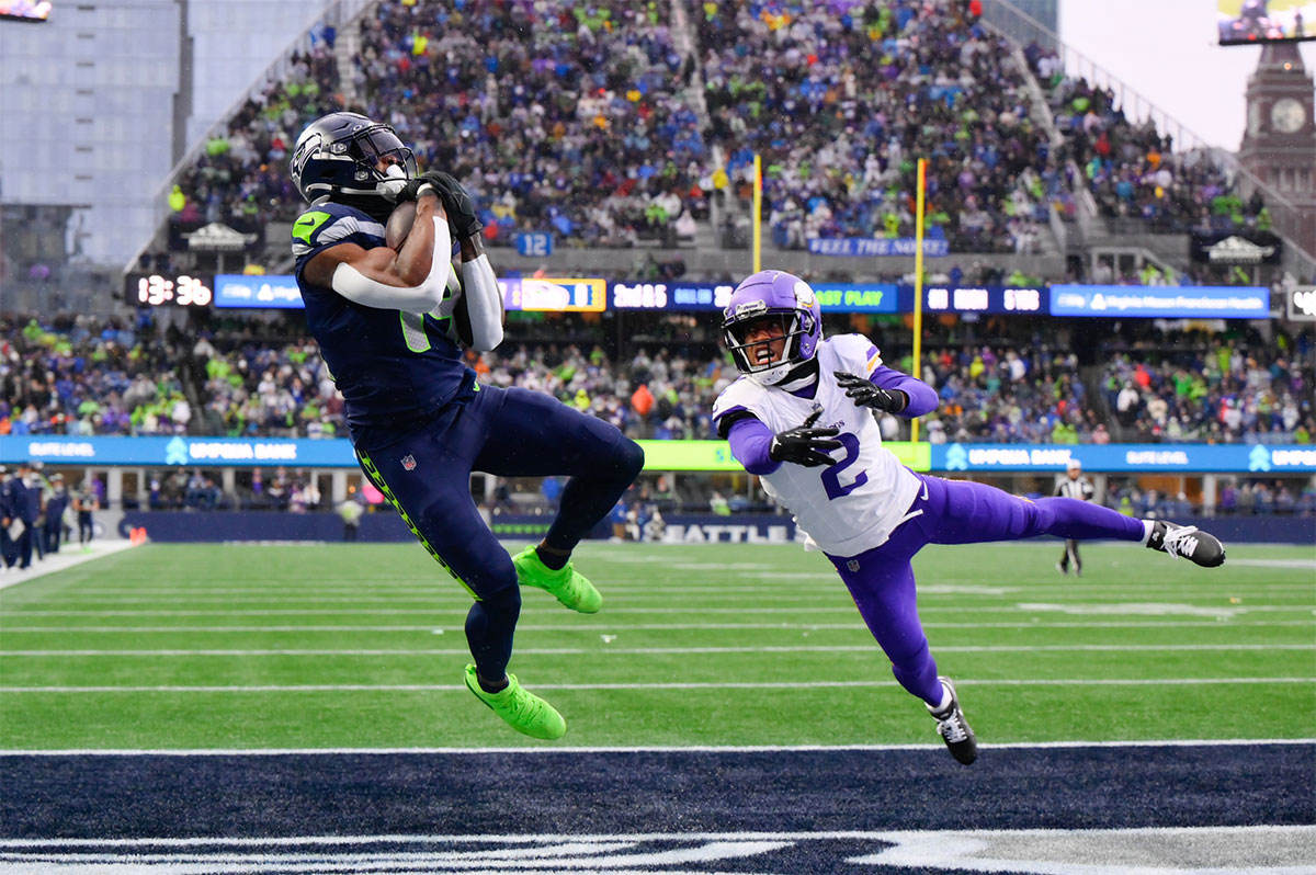 Seattle Seahawks wide receiver DK Metcalf (14) catches a pass for a touchdown over Minnesota Vikings cornerback Stephon Gilmore (2) during the first half at Lumen Field.