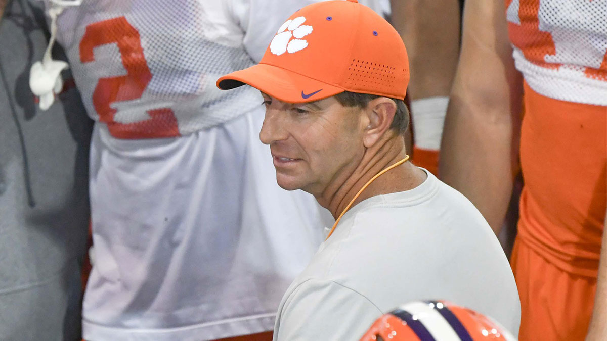 Clemson head coach Dabo Swinney talks with players during the first football practice at the Allen N. Reeves Football Complex at Clemson University