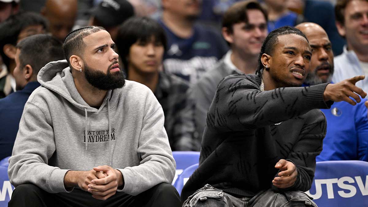 Dallas Mavericks forward Caleb Martin (left) and guard Brandon Williams (right) sit on the bench during the second half against the Sacramento Kings at the American Airlines Center.