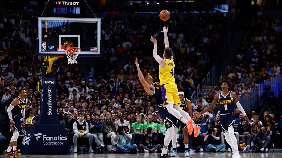 Los Angeles Lakers guard Dalton Knecht (4) attempts a shot as Denver Nuggets forward Michael Porter Jr. (1) guards in the second quarter at Ball Arena.