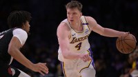 Los Angeles Lakers guard Dalton Knecht (4) is defended by Portland Trail Blazers guard Shaedon Sharpe (17) in the second half at Crypto.com Arena.