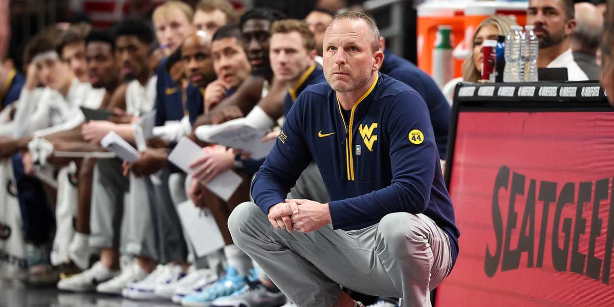 West Virginia Mountaineers coach Darian DeVries watches game play during the first half against the Colorado Buffaloes at T-Mobile Center