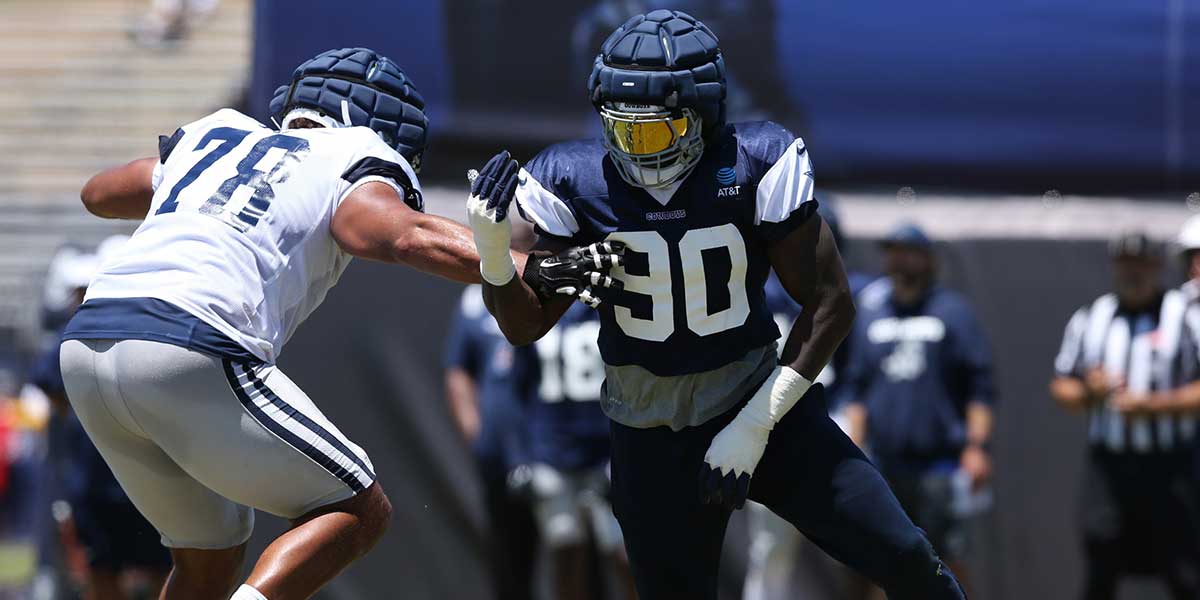 Dallas Cowboys defensive end DeMarcus Lawrence (90) rushes against offensive tackle Terence Steele (78) during training camp at the River Ridge Playing Fields in Oxnard, California. Mandatory Credit: Jason Parkhurst-Imagn Images
