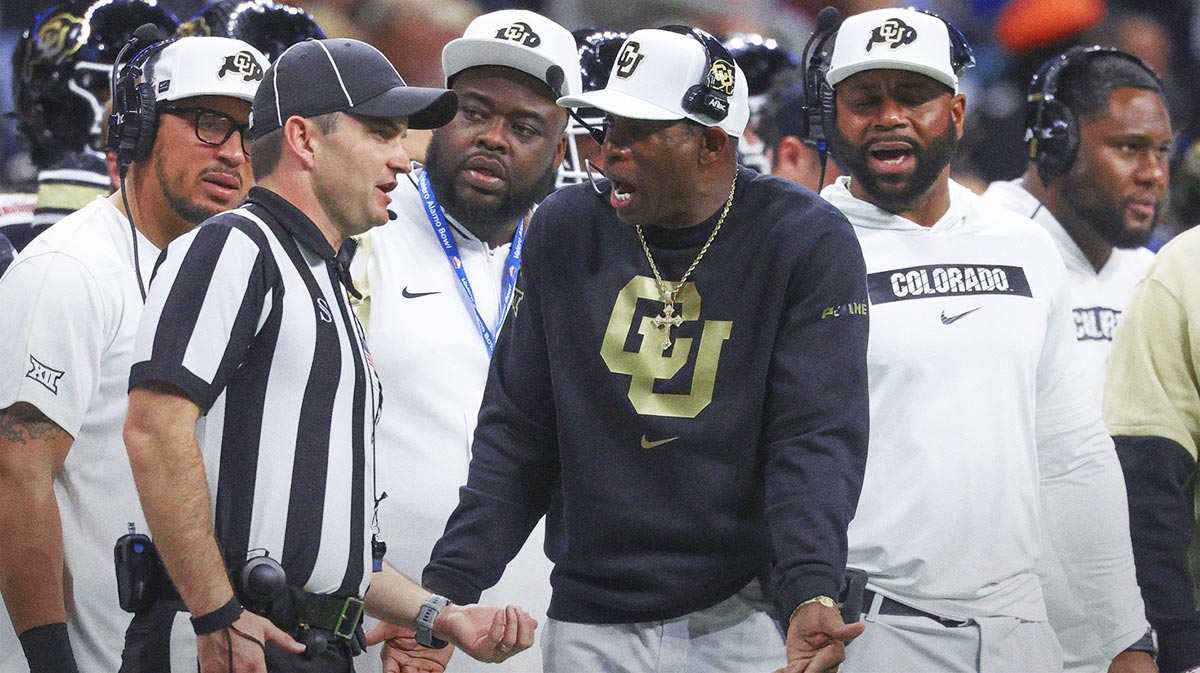 Colorado Buffaloes head coach Deion Sanders reacts with an official after a play during the second quarter against the Brigham Young Cougars at Alamodome.