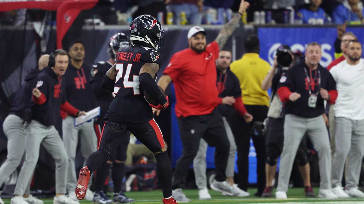 Houston Texans corner back Derek Stingley Jr. (24) runs the ball during the third quarter after an interception against the Los Angeles Chargers in an AFC wild card game at NRG Stadium. 