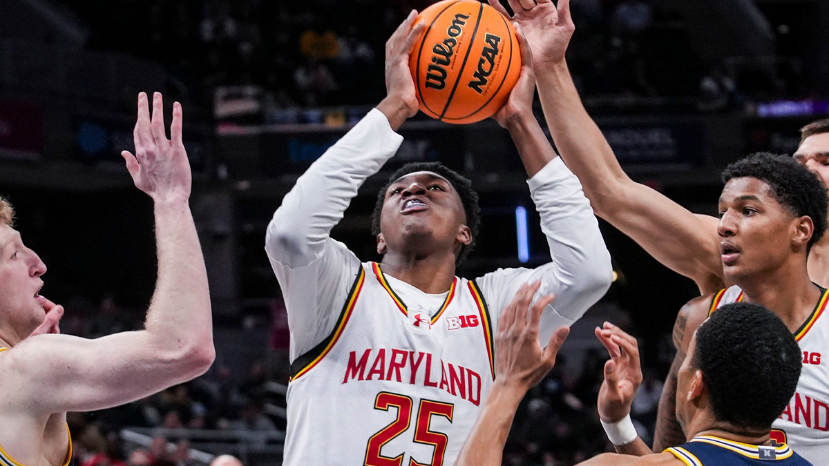 Maryland Terrapins center Derik Queen (25) goes up for a basket against Michigan Wolverines center Danny Wolf (1) and Michigan Wolverines guard Nimari Burnett (4) on Saturday, March 15, 2025, in a semifinals game at the 2025 TIAA Big Ten Men’s Basketball Tournament between the Michigan Wolverines and the Maryland Terrapins at Gainbridge Fieldhouse in Indianapolis.