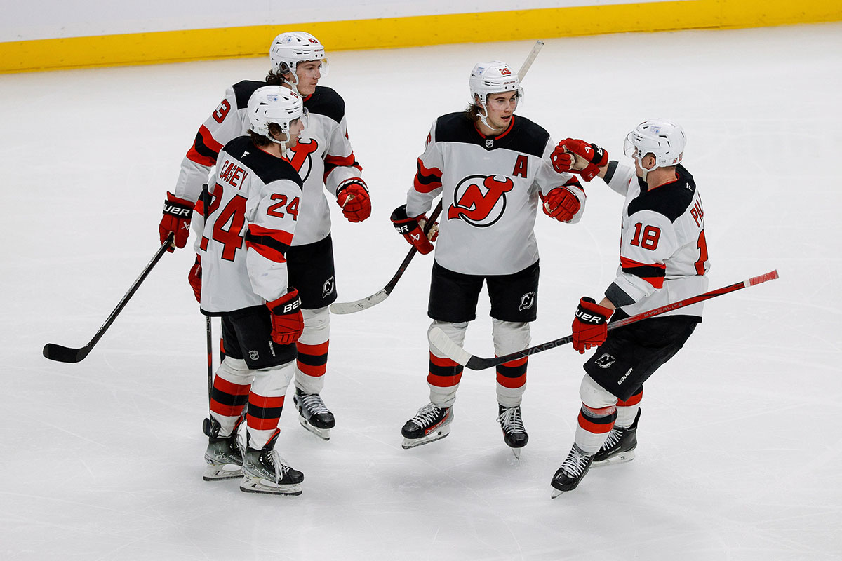 New Jersey Devils center Jack Hughes (86) celebrates his goal with defenseman Luke Hughes (43) and defenseman Seamus Casey (24) and left wing Ondrej Palat (18) in the third period against the Colorado Avalanche at Ball Arena. 