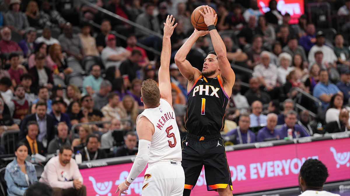 Phoenix Suns guard Devin Booker (1) shoots over Cleveland Cavaliers guard Sam Merrill (5) during the second half at Footprint Center.