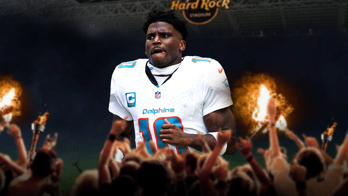 Dolphins logo behind Tyreek Hill standing next to Dolphins fans holding torches and pitchforks. Background is fiery.