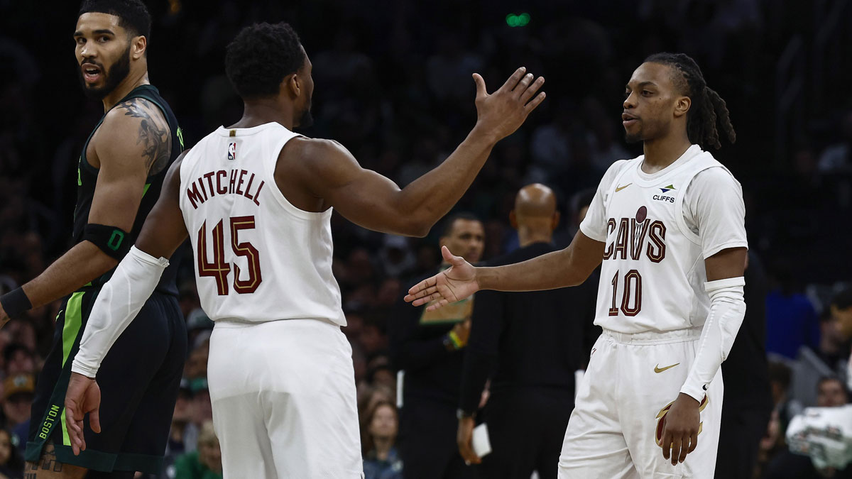 Cleveland Cavaliers guard Donovan Mitchell (45) and guard Darius Garland (10) congratulate each other as Boston Celtics forward Jayson Tatum (0) looks back during the second half at TD Garden.