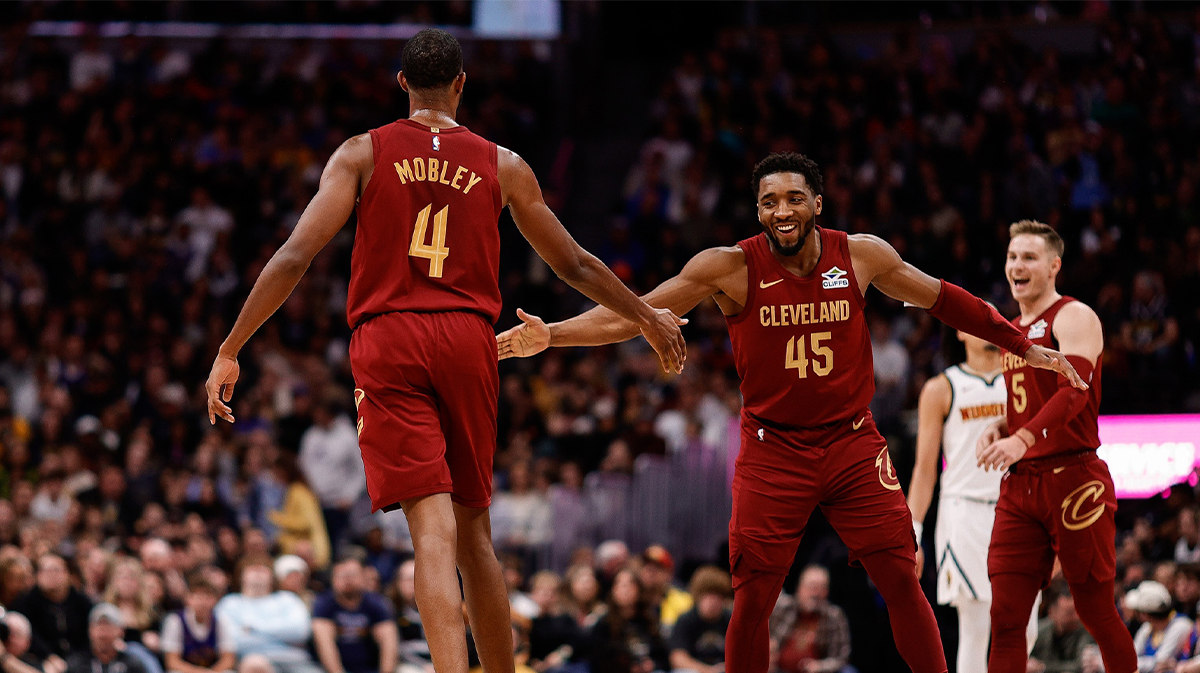 Cleveland Cavaliers guard Donovan Mitchell (45) reacts with forward Evan Mobley (4) after a play in the fourth quarter against the Denver Nuggets at Ball Arena