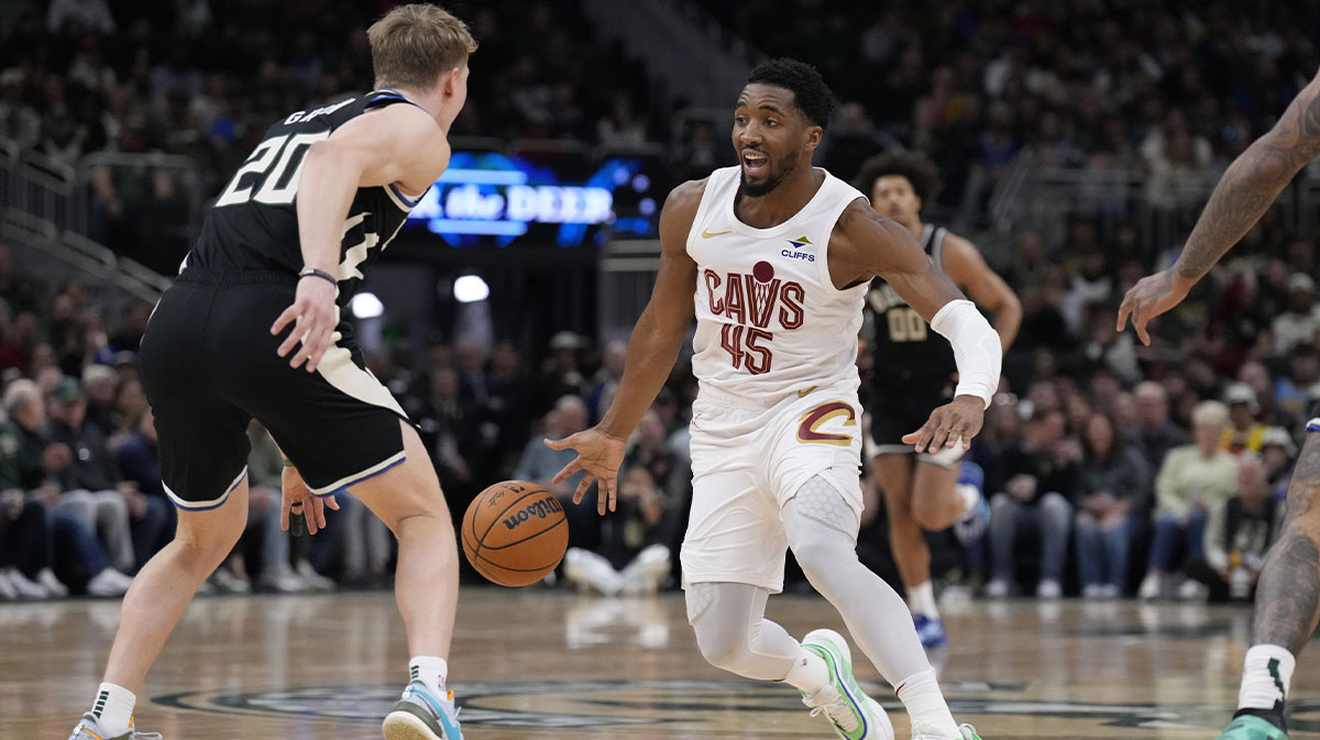 Cleveland Cavaliers Guard Donovan Mitchell (45) Drives against Milvaukee Bucks Guard AJ Green (20) In the first half at Fiserv Forum.