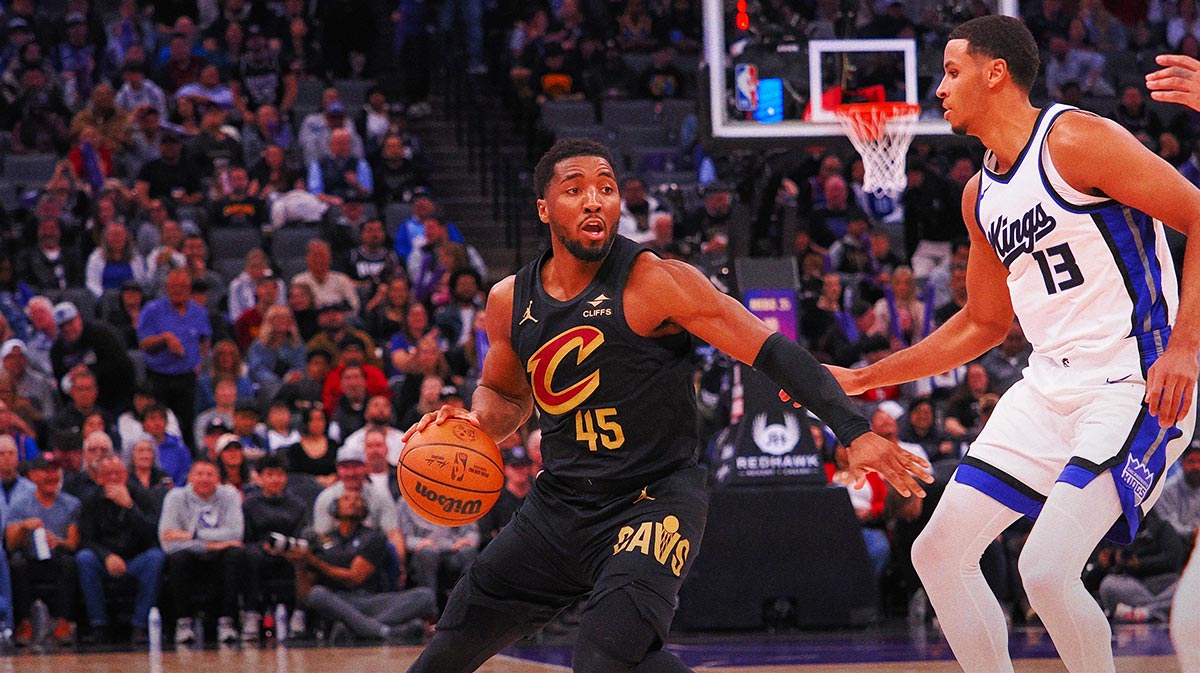 Cleveland Cavaliers guard Donovan Mitchell (45) controls the ball against Sacramento Kings forward Keegan Murray (13) during the third quarter at Golden 1 Center.