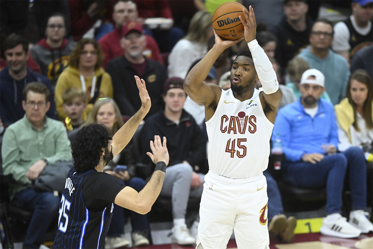 Cleveland Cavaliers guard Donovan Mitchell (45) shoots beside Orlando Magic center Goga Bitadze (35) in the fourth quarter at Rocket Arena.