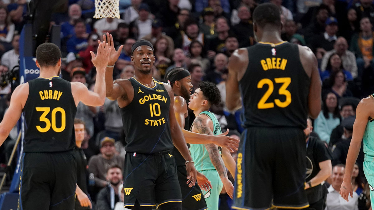 Golden State Warriors forward Jimmy Butler III (10) is congratulated by guard Stephen Curry (30) after a basket against the Charlotte Hornets in the third quarter at the Chase Center.