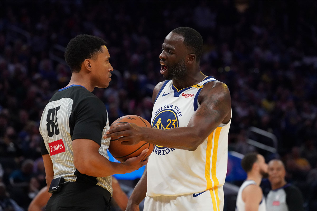 Golden State Warriors forward Draymond Green (23) interacts with a referee during the game against the Detroit Pistons in the fourth quarter at Chase Center.