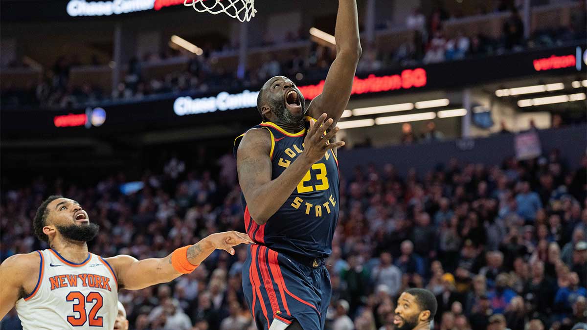 Golden State Warriors forward Draymond Green (23) shoots a layup against New York Knicks center Karl-Anthony Towns (32) during the fourth quarter at Chase Center.