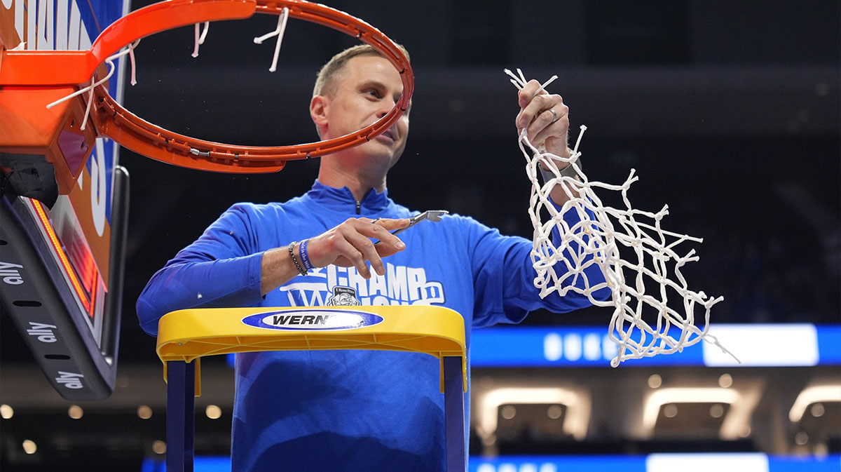 Duke Blue Devils head coach Jon Scheyer cuts the net after winning the 2025 ACC Conference Championship game against the Louisville Cardinals at Spectrum Center.