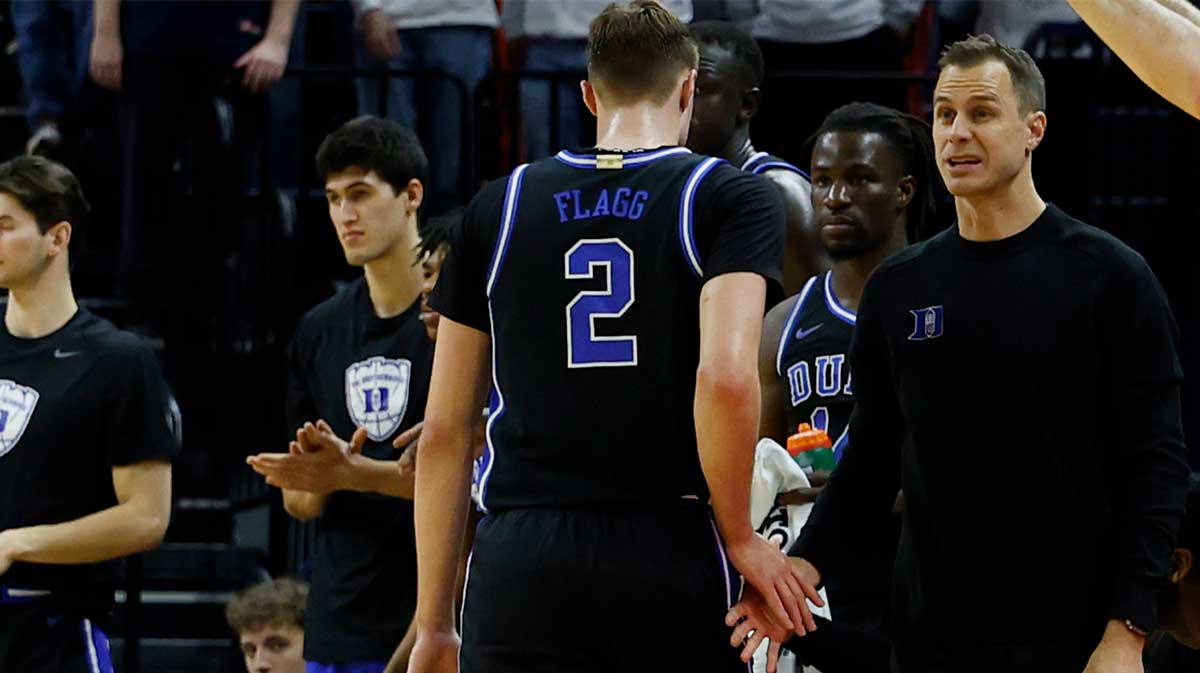 Duke Blue Devils head coach Jon Scheyer shakes hands with Blue Devils guard Cooper Flagg (2) after removing him from the game against the Virginia Cavaliers in the second half at John Paul Jones Arena.