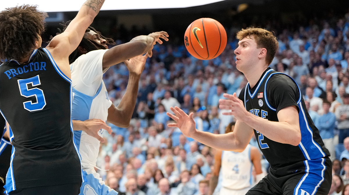 North Carolina Tar Heels guard Ian Jackson (11) with the ball as Duke Blue Devils guard Tyrese Proctor (5) and forward Cooper Flagg (2) defend in the second half at Dean E. Smith Center.