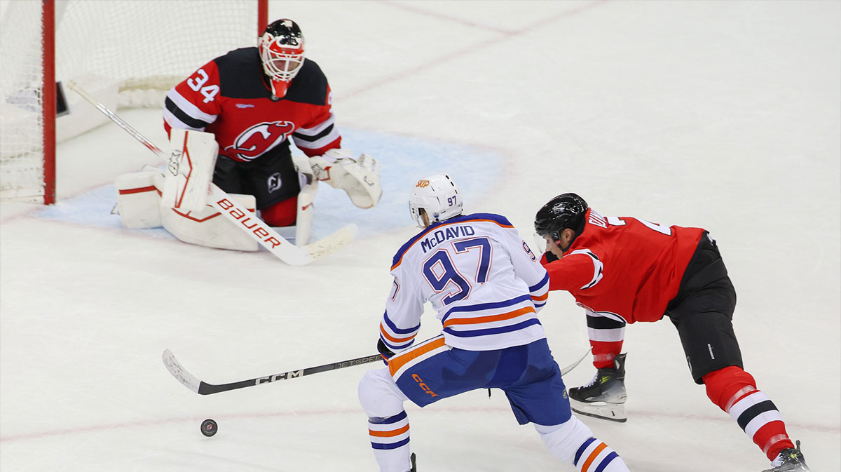 Edmonton Oilers center Connor McDavid (97) plays the puck as New Jersey Devils defenseman Brian Dumoulin (2) defends during the third period at Prudential Center.