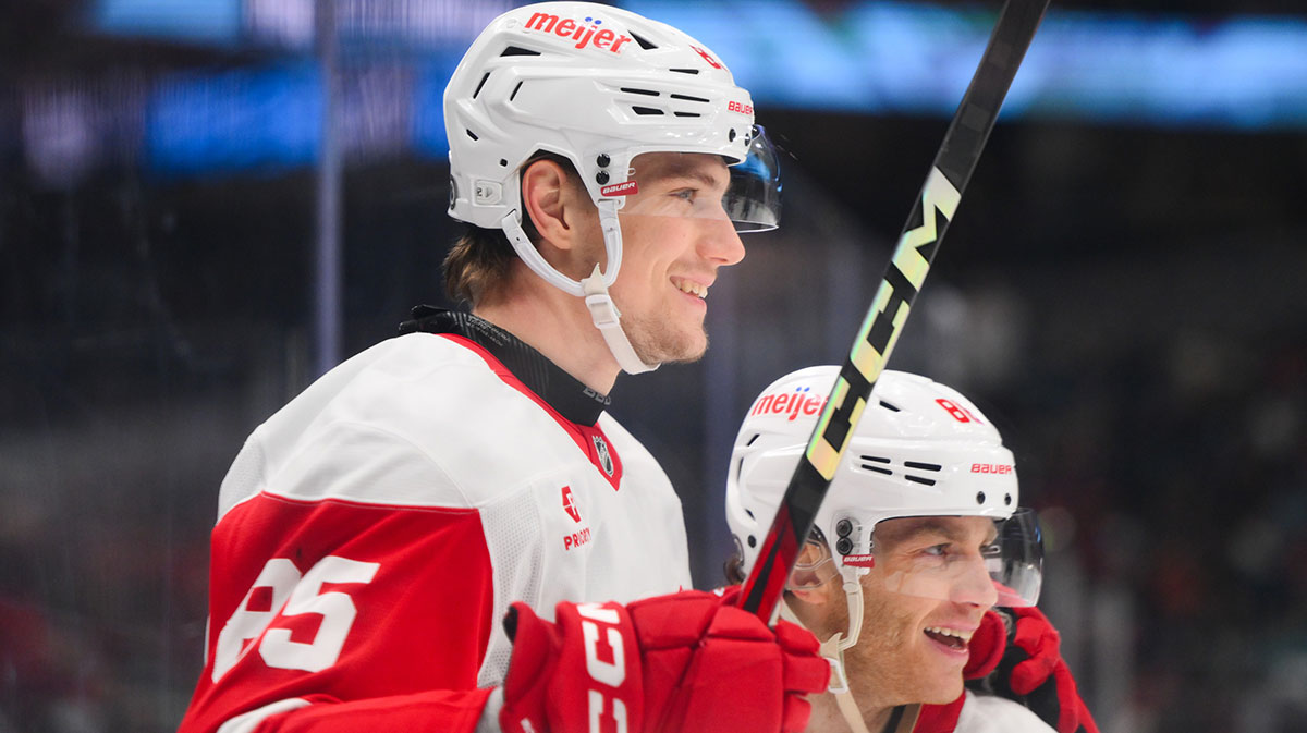 Detroit Red Wings left wing Elmer Soderblom (85) and right wing Patrick Kane (88) celebrate after Soderblom scored a goal against the Seattle Kraken during the third period at Climate Pledge Arena.