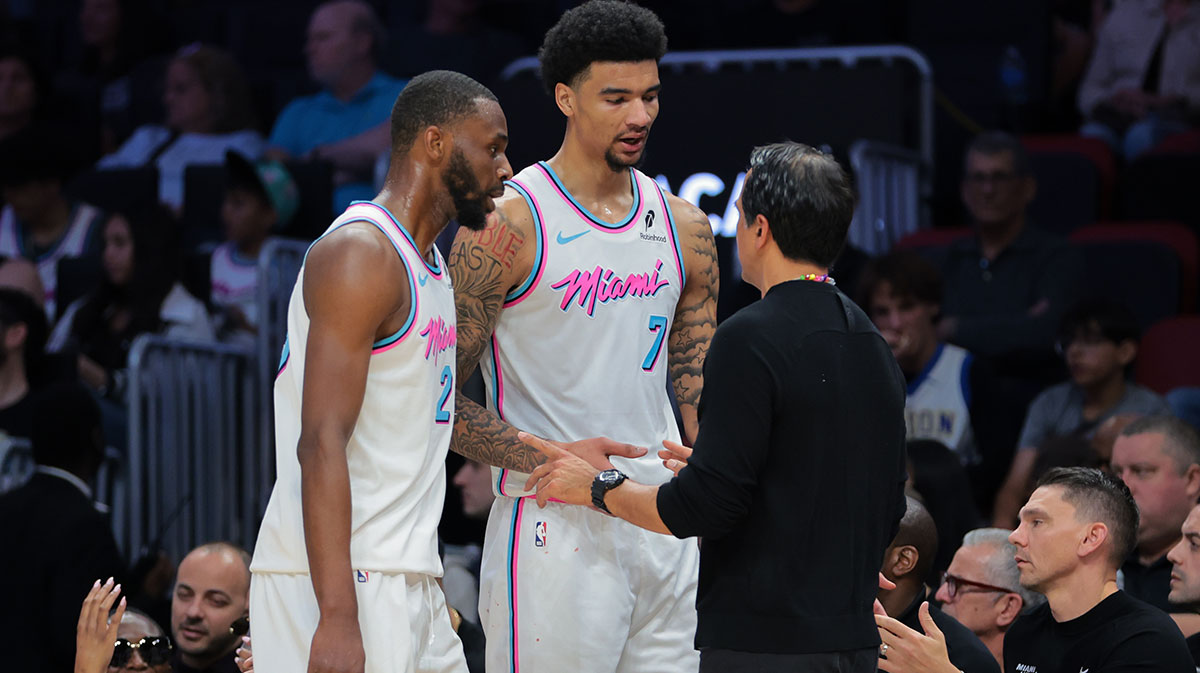 Miami Heat head coach Erik Spoelstra talks to center Kel'el Ware (7) and forward Andrew Wiggins (22) against the Chicago Bulls during the third quarter at Kaseya Center.