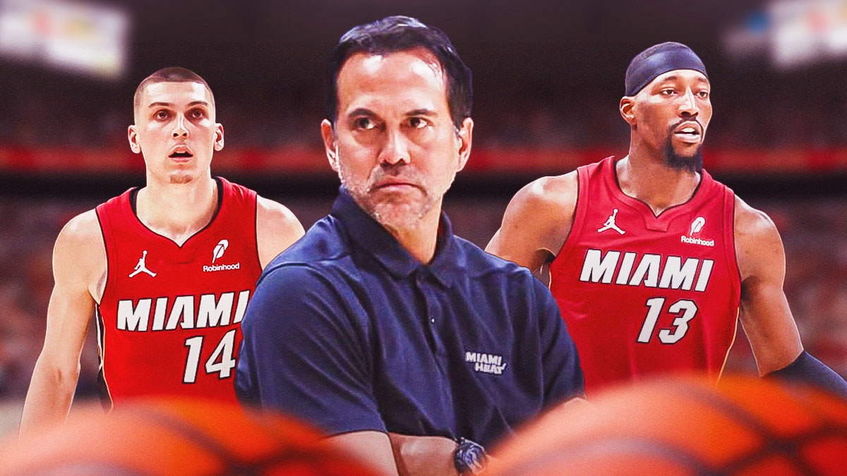 Miami Heat head coach Erik Spoelstra in the middle with Bam Adebayo and Tyler Herro on either side in front of Kaseya Center.