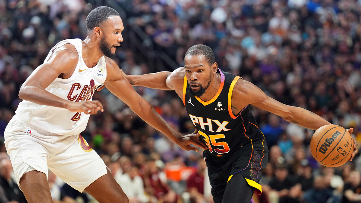 Phoenix Suns forward Kevin Durant (35) dribble against Cleveland Cavaliers forward Evan Mobley (4) during the first half at Footprint Center.