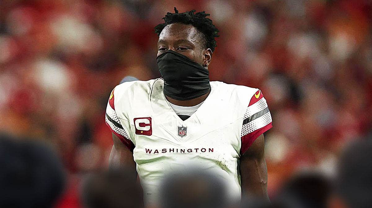Michael Gallup in a Commanders uniform with the Commanders home stadium in the background.