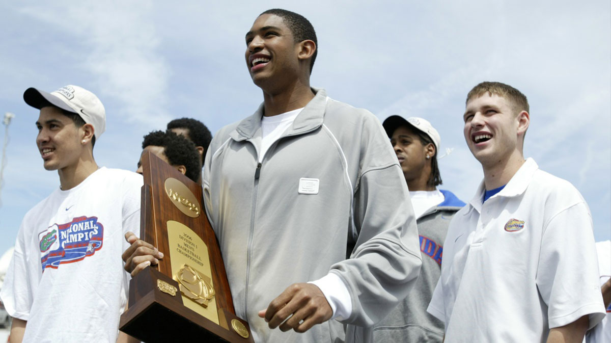 Florida Gators forward Al Horford holds the championship trophy as Lee Humphrey (right) and XXXX celebrate the Gators first NCAA basketball National Championship at the Gainesville Raceway in Gainesville, Florida.