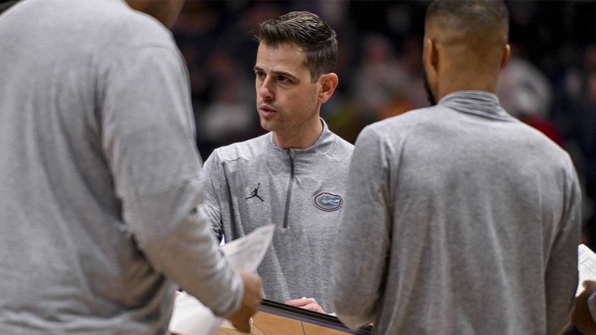 Florida Gators head coach Todd Golden talks with his coaches during a time out against the Alabama Crimson Tide during the second half at Bridgestone Arena.