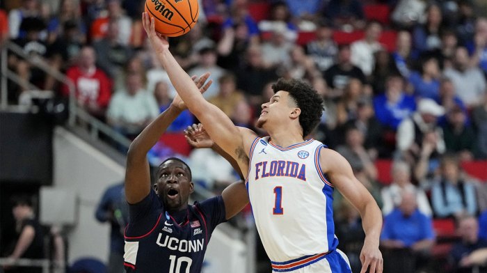 Florida Gators guard Walter Clayton Jr. (1) and Connecticut Huskies guard Hassan Diarra (10) battle for the ball during the first half in the second round of the NCAA Tournament at Lenovo Center.