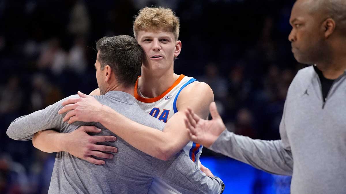 Florida forward Thomas Haugh (10) hungs head coach Todd Golden during final moments of their victory against Alabama during the second half of a Southeastern Conference tournament semifinal game at Bridgestone Arena.