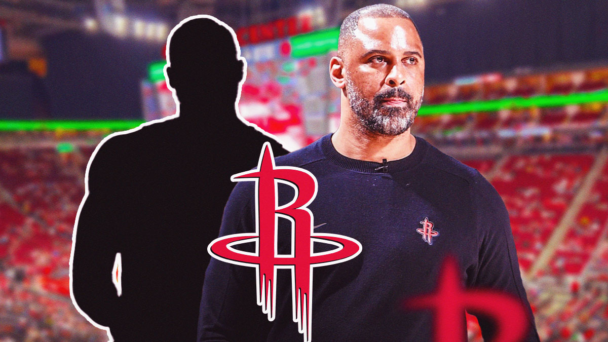 Rockets head coach Ime Udoka next to the Rockets logo with former NBA forward Carlos Boozer (shadowed out) in the background