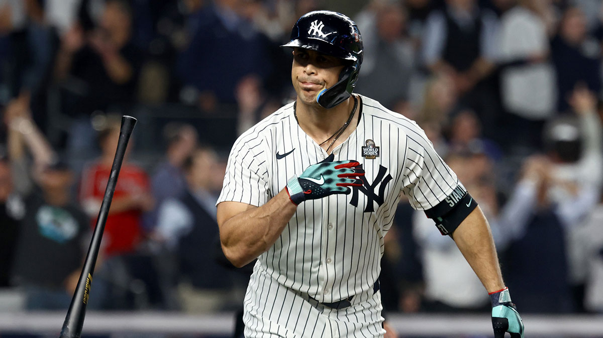 New York Yankees designated hitter Giancarlo Stanton (27) reacts after hitting a home run during the third inning against the Los Angeles Dodgers in game five of the 2024 MLB World Series at Yankee Stadium.