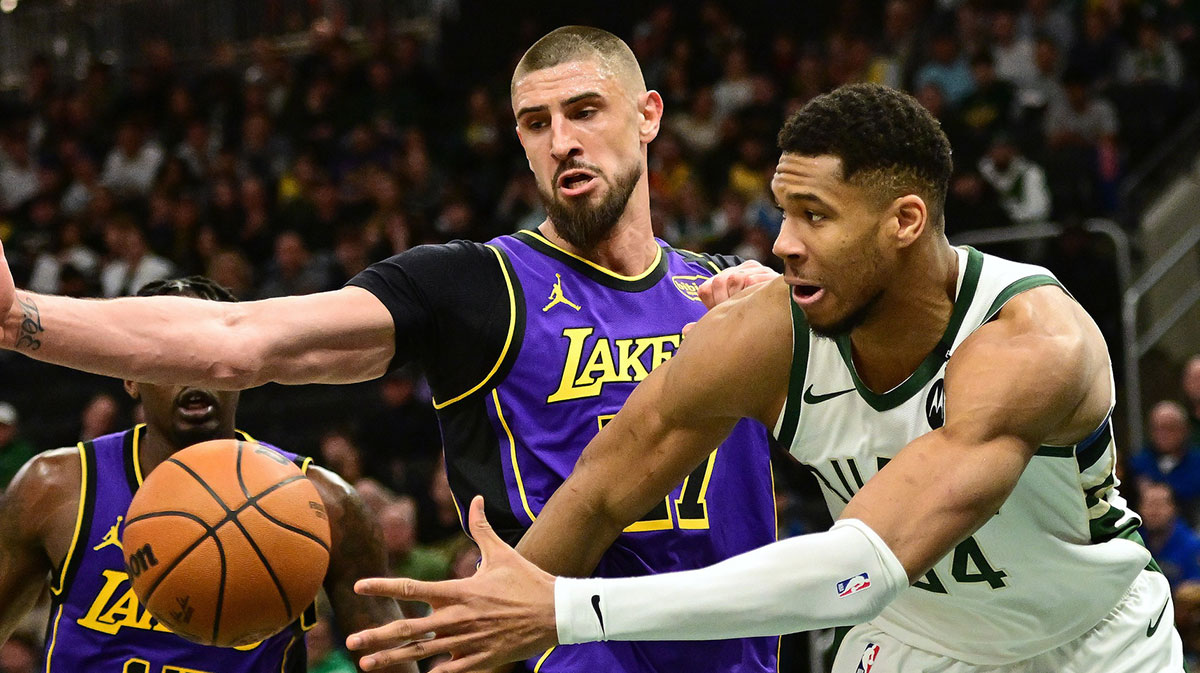 Milwaukee Bucks forward Giannis Antetokounmpo (34) passes the ball away from Los Angeles Lakers center Alex Len (27) in the second quarter at Fiserv Forum.