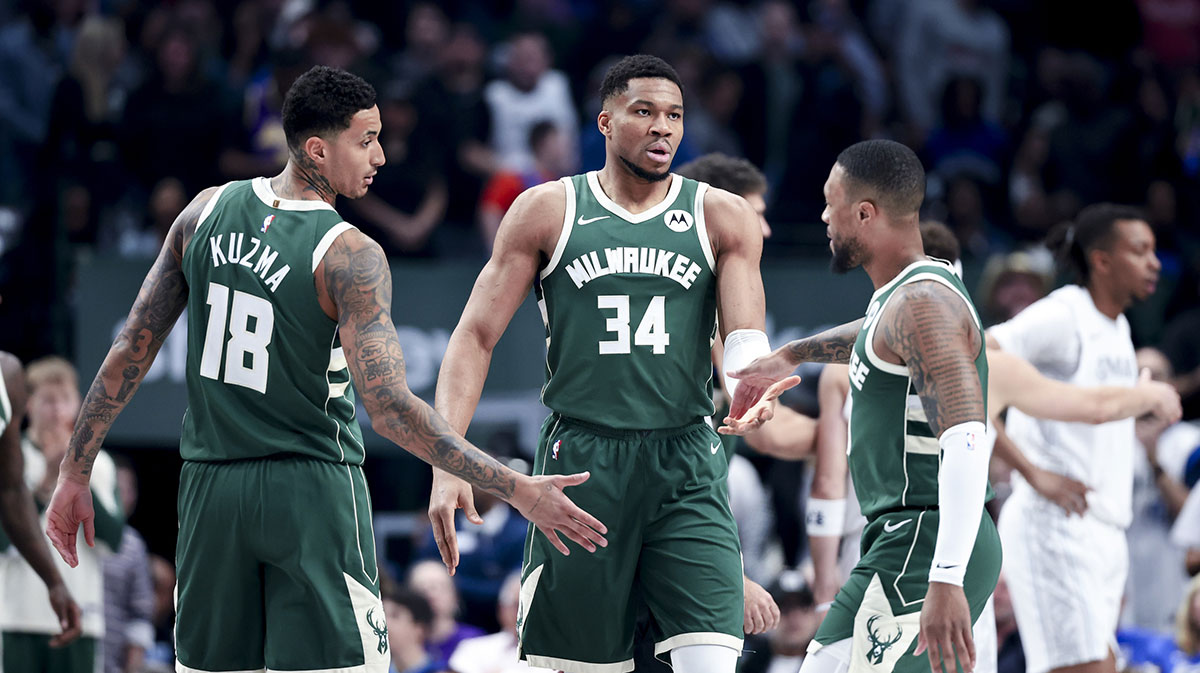 Milwaukee Bucks forward Giannis Antetokounmpo (34) celebrates with Milwaukee Bucks guard Damian Lillard (0) and Milwaukee Bucks forward Kyle Kuzma (18) against the Dallas Mavericks during the first half at American Airlines Center.