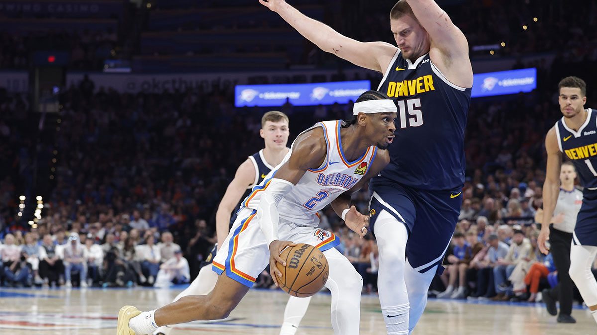 Oklahoma City Thunder Guard Shai Gilgeous-Alexander (2) Drive against Denver Nugget Center Nikola Jokic (15) during the second half in the center of Paicom.