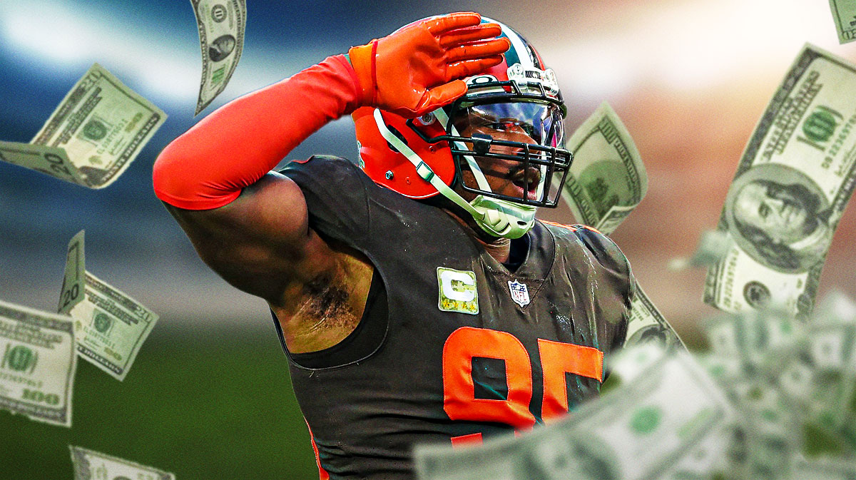 Cleveland Browns defensive end Myles Garrett with money falling all around him