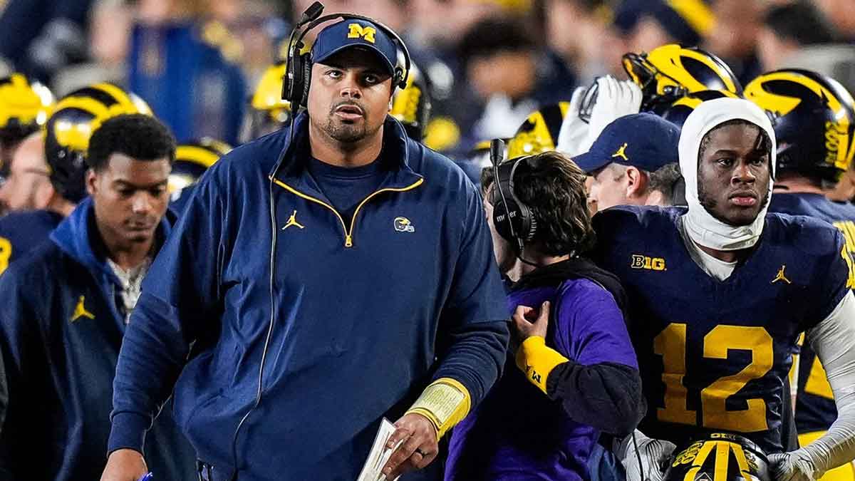 Michigan offensive line coach Grant Newsome looks on after a play against Michigan State during the first half at Michigan Stadium