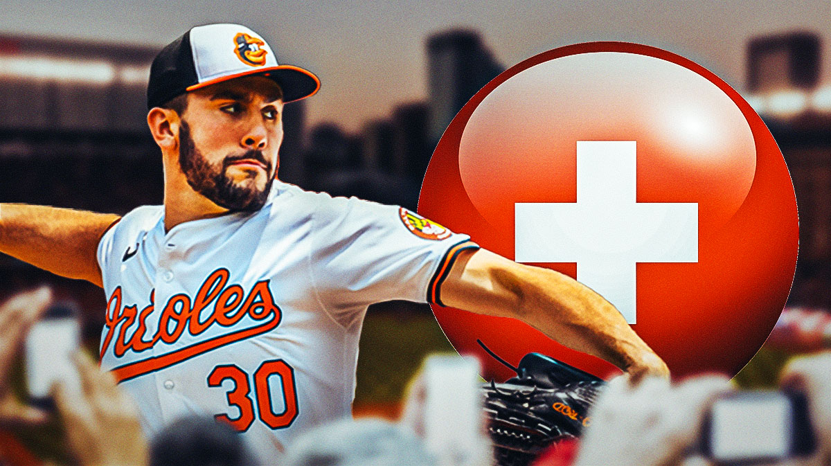 Grayson Rodriguez in a Baltimore Orioles uniform with a red and white first aid symbol as rodriguez is dealing with an injury during spring training for the orioles.