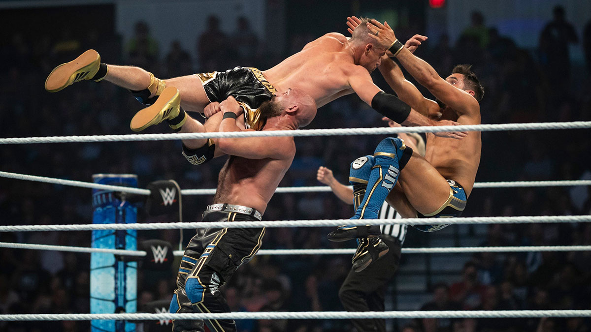 Grayson Waller fighting Tomasso Ciampa and Johnny Gargano on SmackDown in 2024.