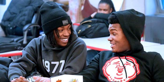 Marshall High School students Levardis Bentley, 18, left and Gabriel Houston, right, are all smiles on Wednesday, Dec. 18, 2024, after learning that their class will be heading to Ghana for a class trip in May.