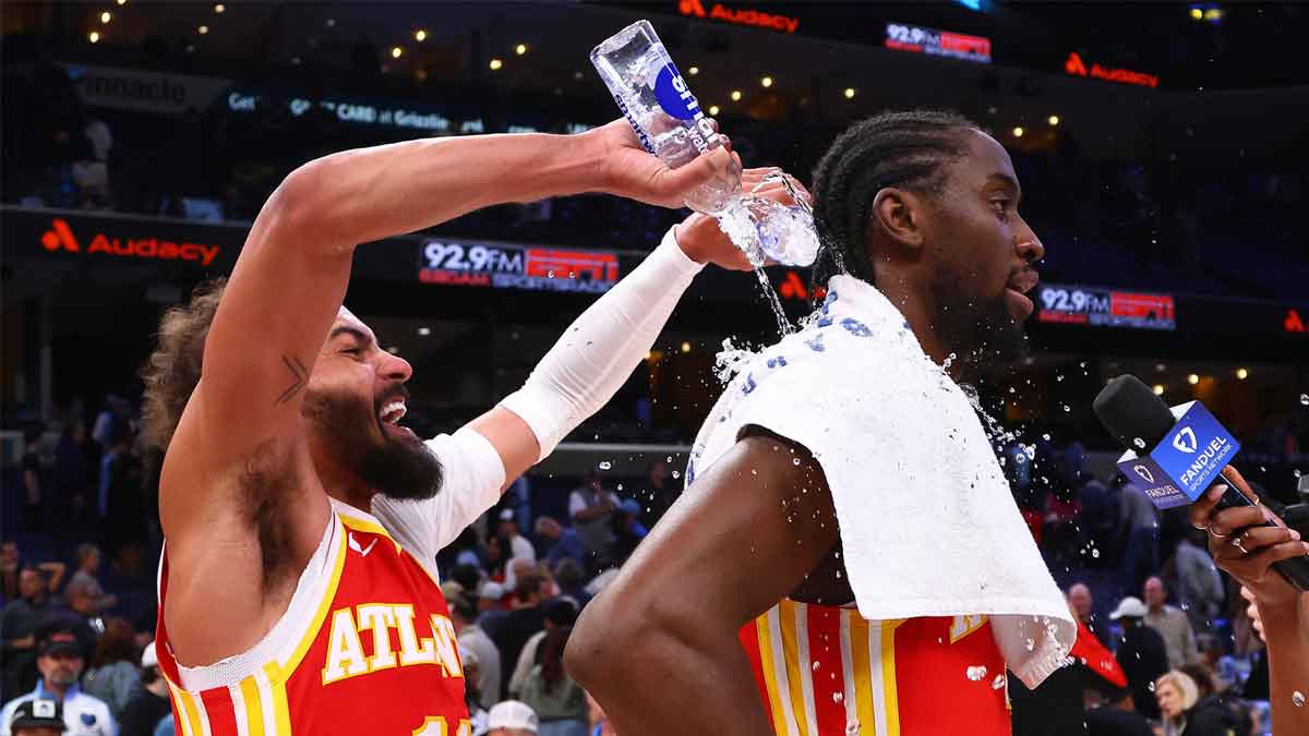 Hawks guard Trae Young (11) dumps water on guard Caris LeVert