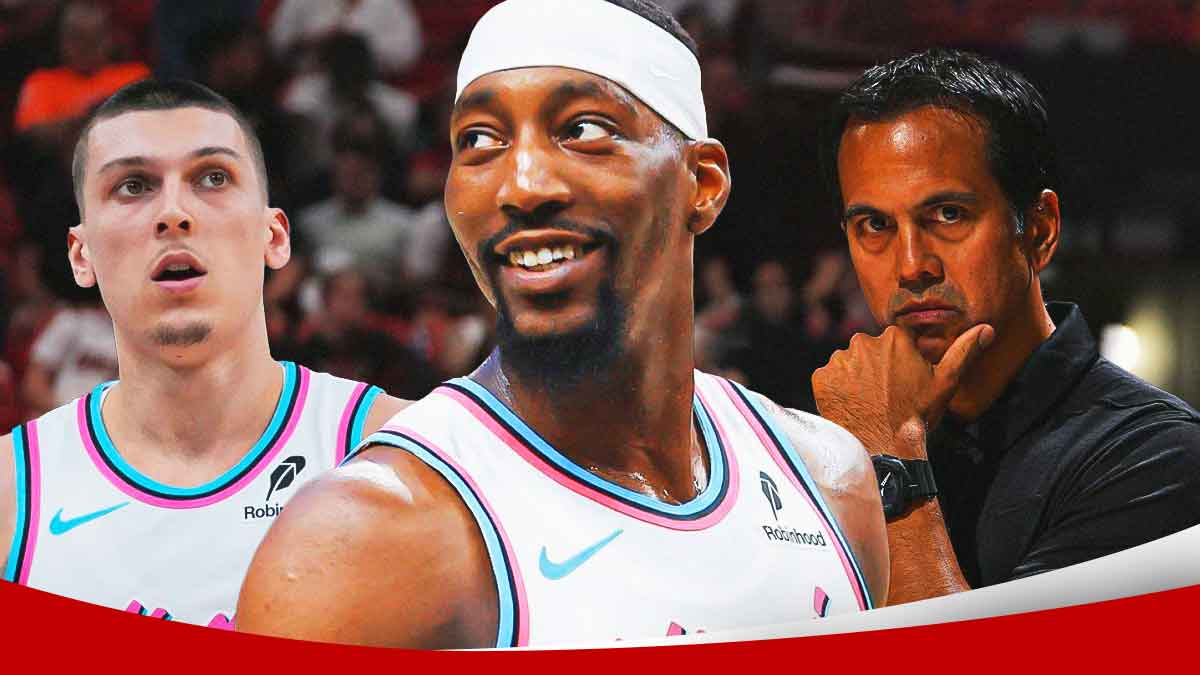 Miami Heat star Bam Adebayo in the middle with Tyler Herro and Erik Spoelstra on either side in front of Kaseya Center.